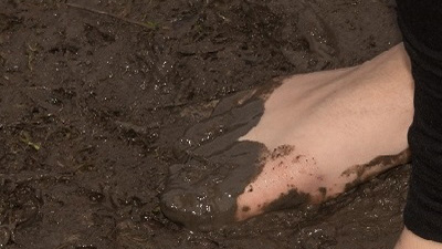 a foot sinking into the mud