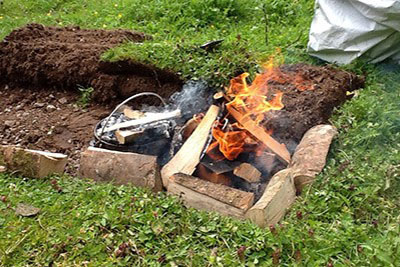 dug out fire pit with burning fire